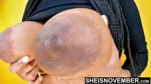 Ebony babe squeezing her massive bare huge tits together topless closeup