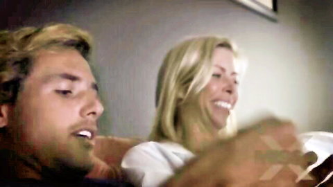 Alexis Fawx and Tyler Nixon sharing cozy movie night on couch