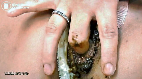 Asian woman fingering pussy with visible shit scat play