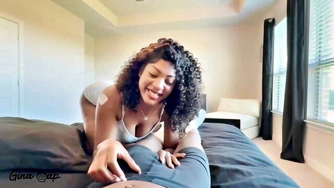 Smiling curly-haired big tits babe tugs at guy's pants crotch in POV bedroom tease