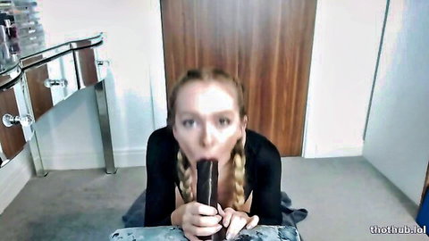 Brea Rose blonde with pigtails deepthroating black dildo on knees