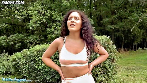 Liv Revamped fitness model posing in white sportswear outdoors