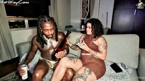 Hikey and Top Tier, tattooed ebony couple, sharing wine intimately in sexy outfits