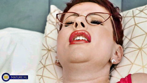 Redhead Lisa Pinelli in glasses and lingerie, sensual open-mouth tease