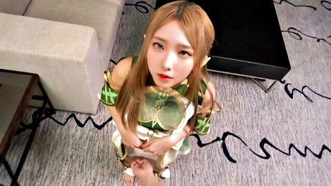Blonde elf AINALIND in revealing green fantasy outfit, kneeling seductively