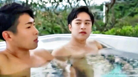 Two hot Japanese men in steamy hot tub, intense gay gaze