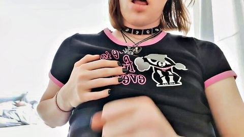 Ivy Lust close-up with tongue out, hand on chest in black graphic tee