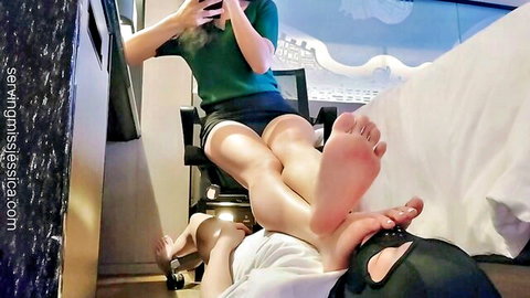 Miss Jessica dominates M-male slave with bare feet on hooded face, foot fetish