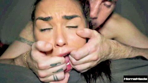 Tattooed man grips petite babe's face and shoves fingers in her open moaning mouth homemade