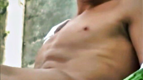 Shirtless muscular man lounging outdoors in #Outdoorboys series