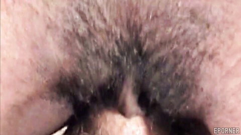 Closeup of hairy ebony pussy with thick bush framing wet pink labia lips