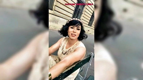Elegant French ladyboy in beaded dress posing at Eiffel Tower, outdoor tease
