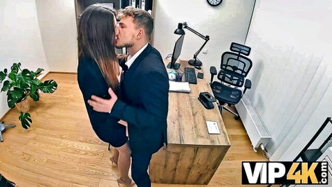 Brunette office babe in skirt passionately kissing suited man against desk