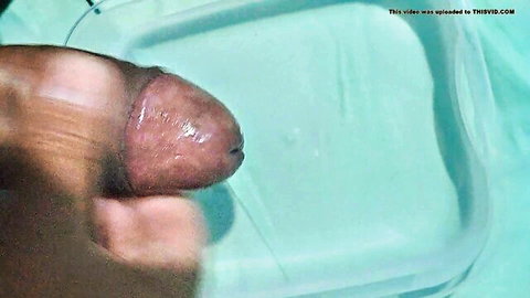 Black hand gripping thick erect BBC cock with shiny circumcised head closeup