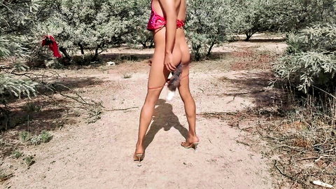 Hot trans babe in pink bikini exposes anal tail plug outdoors in high heels