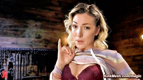 Seductive blonde babe in sheer shawl and bra flashing deep cleavage while pointing teasingly