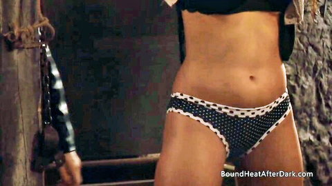 Bound busty woman in polka dot panties enduring lesbian domination and whipping