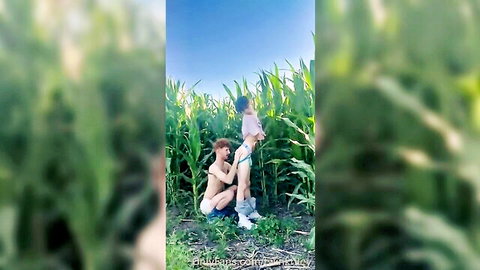 Two slim young men in outdoor gay rimming scene in cornfield, ass exposed