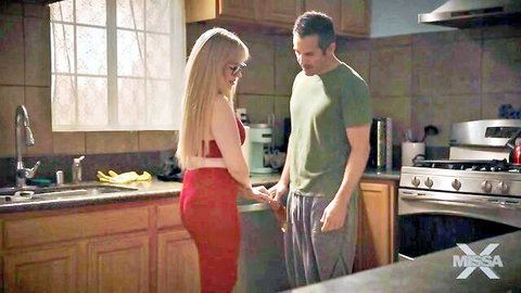 Blonde Jessica Ryan in red lingerie holding hands with man in intimate kitchen moment