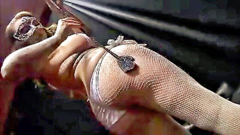 Harmony Reigns in masquerade mask, paddle spank pose with big ass in fishnets