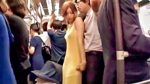 Japanese woman in yellow dress teased by men on crowded subway train