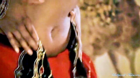 Indian babe in erotic close-up with gold necklace and red dress
