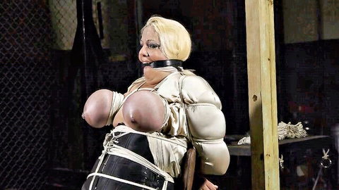 Busty blonde dominatrix bound, gagged and exposed in intense BDSM scene