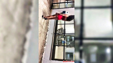 Ebony woman in short red dress flashing curvy ass outdoors at night