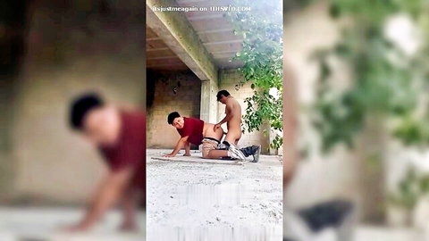 Naked guy fucking bent-over dude in red shirt doggy style in blurry outdoor garage