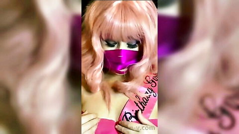 Pink-haired solo girl in purple mask and birthday sash exposes massive fake tits