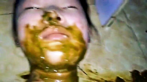 Asian woman with shit smeared on face in scat fetish video
