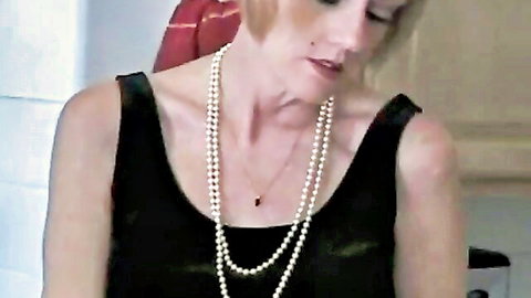 Amateur granny in black dress with pearls gives blowjob in kitchen