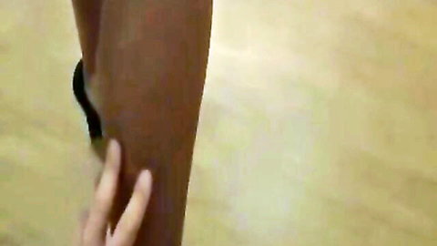 Ebony woman's thigh in black high heels touched intimately