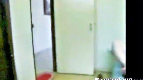 Open white hotel door with red mat in empty room interior