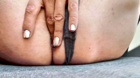 Pale babe spreads round ass cheeks with white nails inserting thick black dildo in tight anus