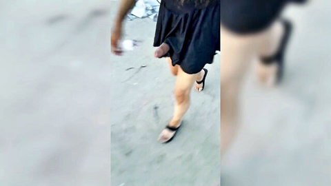 Beautiful trans in black dress and sandals undressing in public