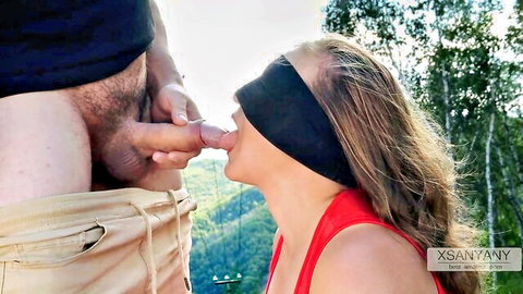 Blindfolded blonde woman orally teasing man's cock outdoors in Desi Indian taste game video