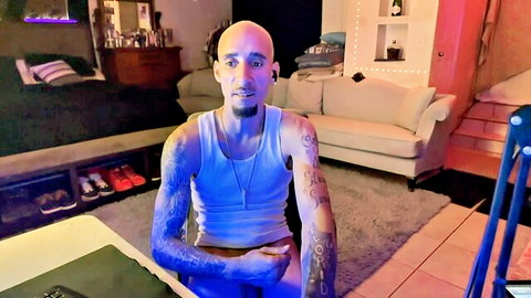 Tattooed bald muscular man in tank top, gay group video preview