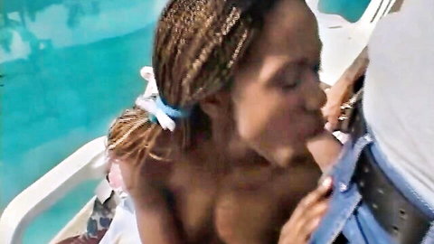 Ebony woman topless kissing white man on boat, outdoor interracial passion