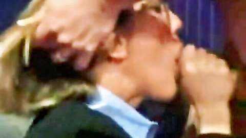 Blonde woman with glasses in blouse about to give blowjob