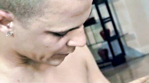 Intense close-up of shirtless bald man with earrings in hardcore scene