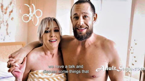 Dee Williams in towel hugging shirtless partner during intimate talk