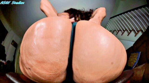 Enchantress Sahrye giant booty tease in teal thong, close-up view