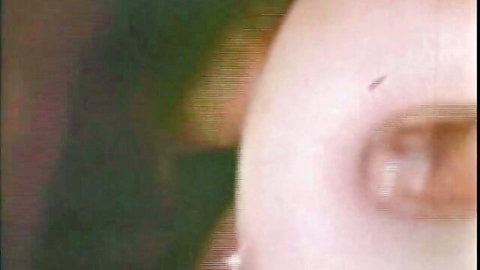 Blurry vintage close-up of brunette's mouth stretched around thick cock