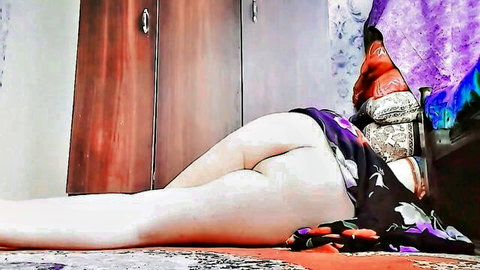 Asian babe lies on bedroom floor legs spread exposing bare pussy and ass cheeks