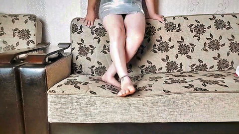 Teen girl spreads legs wide on floral couch flashing shaved pussy and bare feet