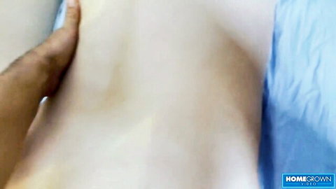 Kira's oiled pale body gripped by hand in homemade scene