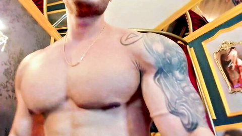 Muscular Atlas Stone shirtless, showcasing tattoos and ripped physique