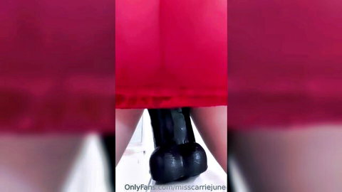 Miss Carriejune teases with 14-inch black dildo under red dress
