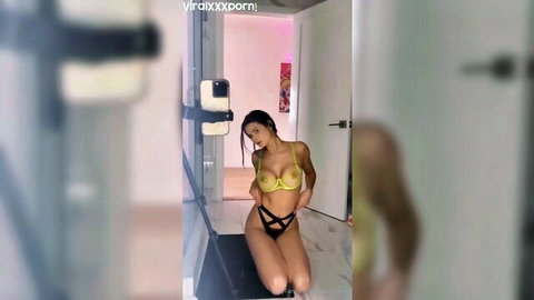 Katie Bell teasing in yellow lingerie, seductive solo pose